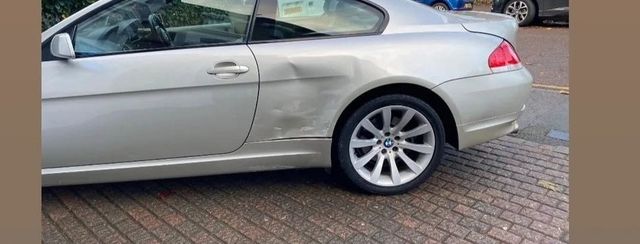 BMW 6 Series with dented door and rear quarter panel, before repair