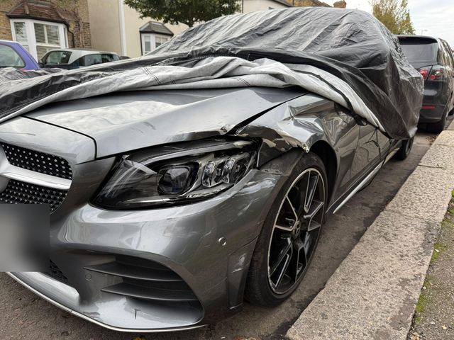 Grey Mercedes C-Class with crumpled bonnet, wing and bumper, before repair