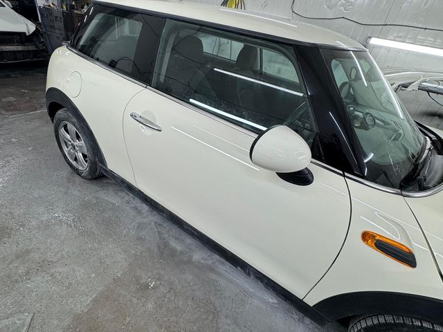 Same Mini Cooper with door repaired and resprayed, back in the workshop