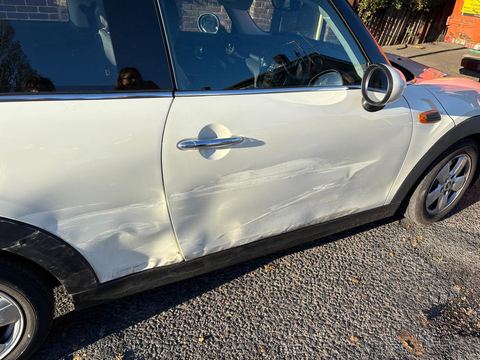 Mini Cooper door scraped and dented on arrival